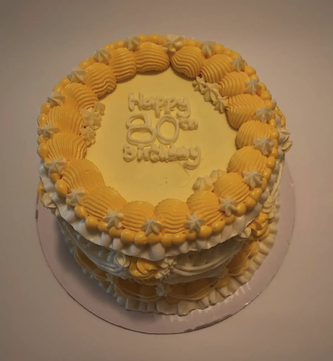 A butter yellow cake with a heavy piped shell border top and bottom