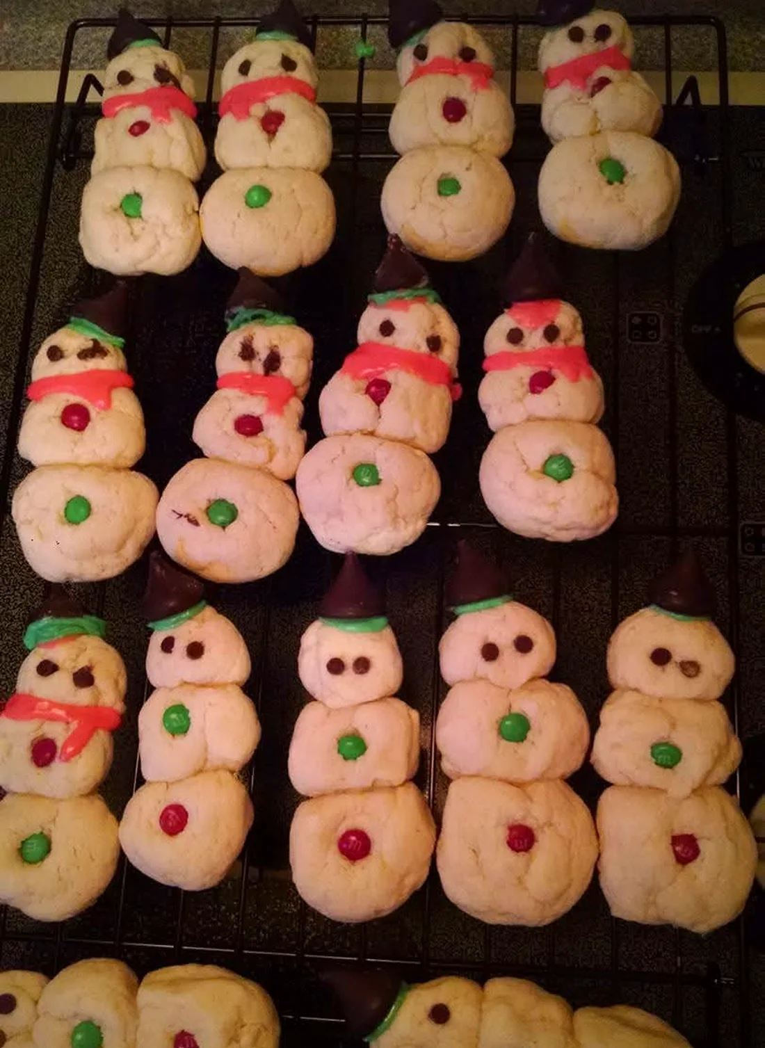 Trays of Ava's decorated sugar cookies cooling on wire racks